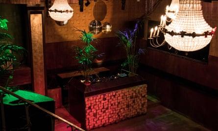 Ornate chandeliers hang from the ceiling in thsi scene of the plush and colourful reception area at club Claire, Amsterdam.