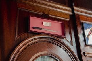 The dark wood interiors solid mahogany bar brown leather booths and traditional patterned carpet nod to the buildings...